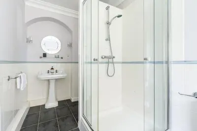 a bathroom with a shower and a sink at Large Grade II Listed House & Garden nr Beaches in Saint Columb Major