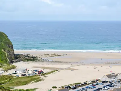 an aerial view of a beach with cars parked at Swallows in Mount Hawke