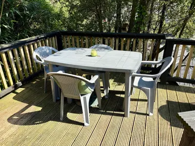 a white table and chairs on a deck at The Fishermans Daughters in Looe