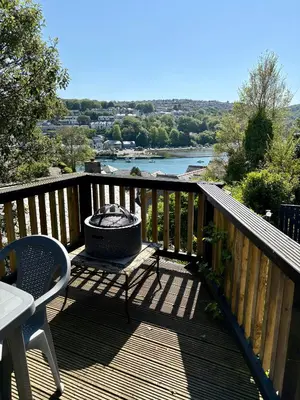 a grill on a deck with a view of a river at The Fishermans Daughters in Looe