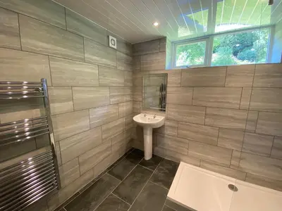 a bathroom with a sink and a mirror at Rosecraddoc Manor - Coachman's in Saint Cleer