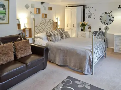 a living room with a bed and a couch at Rosecraddoc Manor - Heron in Saint Cleer
