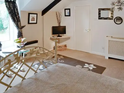a living room with a glass table and a television at Rosecraddoc Manor - Heron in Saint Cleer