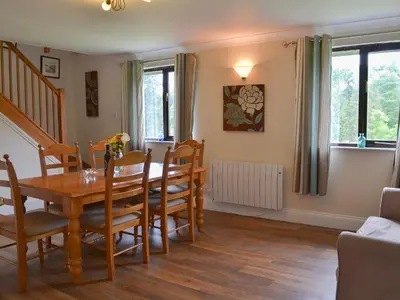 a dining room with a table and chairs at Rosecraddoc Manor - Lakeview in Saint Cleer