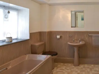 a bathroom with a tub and a toilet and a sink at Rosecraddoc Manor - Natalie Jane in Saint Cleer