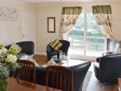 a living room with a couch and chairs and a table at Rosecraddoc Manor - Riverview in Saint Cleer