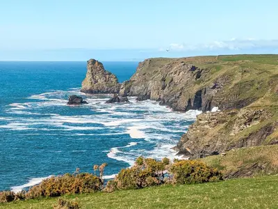 a view of the ocean from a cliff at Pillar Box Cottage in Tintagel