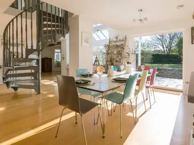 a dining room with a table and chairs at Moorlands Bungalow in Wadebridge