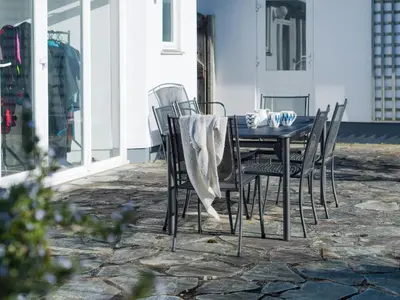 a black table and chairs on a patio at Moorlands Bungalow in Wadebridge