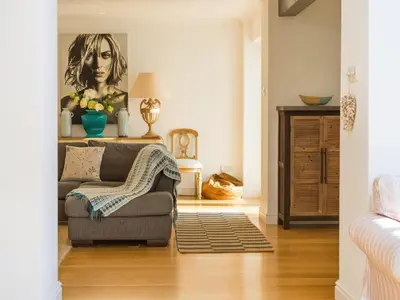 a living room with a couch and a painting on the wall at Moorlands Bungalow in Wadebridge
