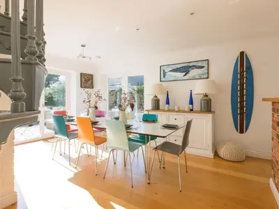 a dining room with a table and chairs at Moorlands Bungalow in Wadebridge