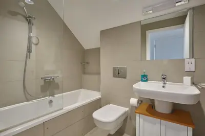 a bathroom with a sink and a toilet and a shower at Stunning Apartment Balcony Sea Views St Ives in St Ives