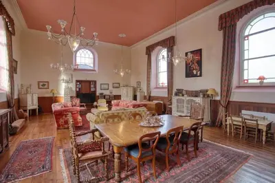 a large living room with a table and chairs at Historic Chapel Great Facilities nr Beaches in Saint Ewe