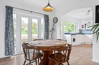a dining room with a wooden table and chairs at Peaceful Home in Looe with Stunning Views in Looe