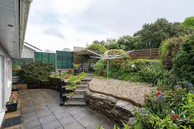 a backyard with a garden with stairs and flowers at Peaceful Home in Looe with Stunning Views in Looe