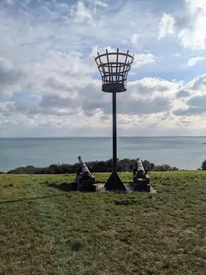 two motorcycles parked in a field next to a light pole at Peaceful Home in Looe with Stunning Views in Looe