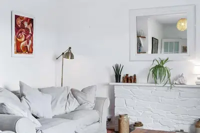 a living room with a white couch and a mirror at Peaceful Home in Looe with Stunning Views in Looe