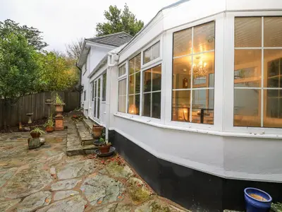 a house with large windows on the side of it at Dowager Cottage in Penryn