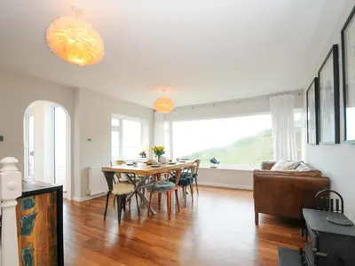 a kitchen and dining room with a table and chairs at Waves Edge in Torpoint