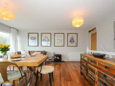 a living room with a table and a dining room at Waves Edge in Torpoint