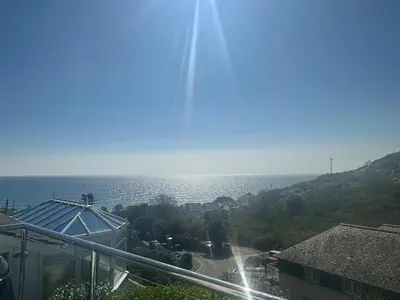 a view of the ocean from a balcony of a building at Waves Edge in Torpoint