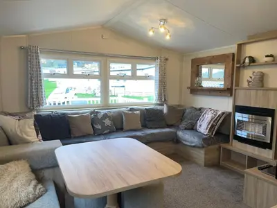 a living room with a couch and a table at 62 Newquay Bay Resort Pet Friendly in Newquay