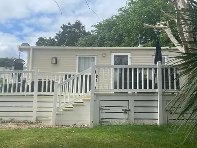 a small house with a porch and a deck at 62 Newquay Bay Resort Pet Friendly in Newquay