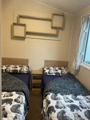 a room with two beds and a window at 62 Newquay Bay Resort Pet Friendly in Newquay