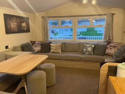a living room with a couch and a table at 62 Newquay Bay Resort Pet Friendly in Newquay