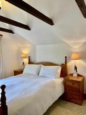 a bedroom with a large bed with two night stands at The Hay Loft in Bude