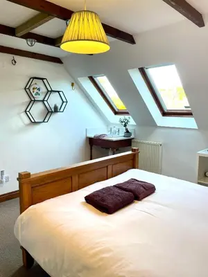 a bedroom with a large bed in a attic at The Hay Loft in Bude