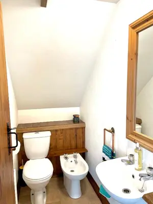 a bathroom with a toilet and a sink at The Hay Loft in Bude