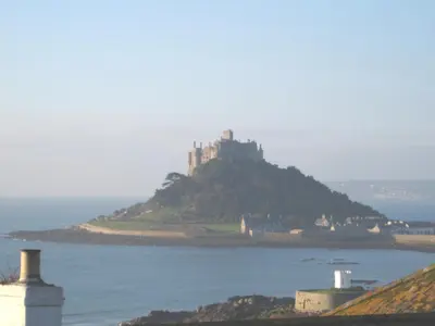 a castle on top of an island in the water at Romantic cottage with fantastic coastal views in Marazion