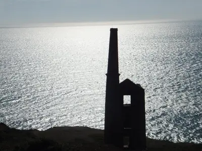 a silhouette of a tower in front of the ocean at Romantic cottage with fantastic coastal views in Marazion