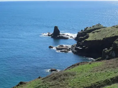 a rock formation in the ocean on a cliff at Romantic cottage with fantastic coastal views in Marazion