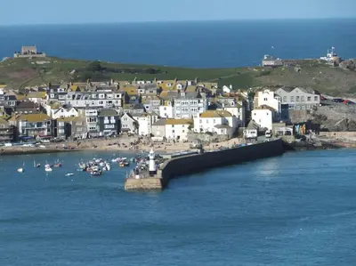 a group of houses and boats in the water at Romantic cottage with fantastic coastal views in Marazion