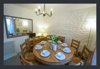 a dining room with a wooden table and chairs at No 11 Fish Street, St Ives in St Ives