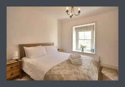 a bedroom with a bed and a window at No 11 Fish Street, St Ives in St Ives