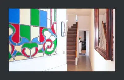 a room with a colorful tile wall and a staircase at No 11 Fish Street, St Ives in St Ives
