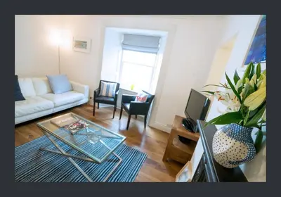 a living room with a couch and a table at No 11 Fish Street, St Ives in St Ives