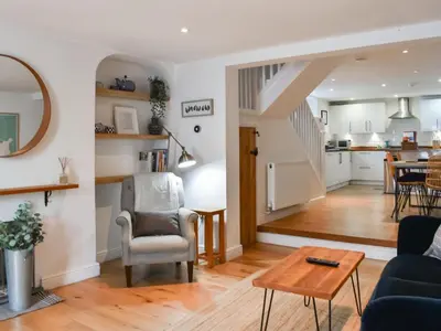 a living room with a couch and a table at Stones Throw in Padstow