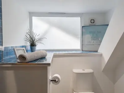 a bathroom with a toilet and a window at Stones Throw in Padstow