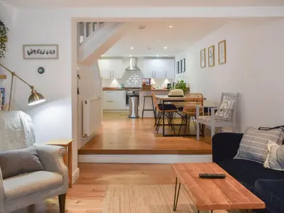 a living room with a couch and a table at Stones Throw in Padstow
