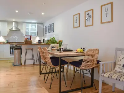 a kitchen and dining room with a table and chairs at Stones Throw in Padstow
