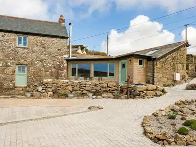 a stone house with a stone wall at Cottage Uk48457 in St Ives