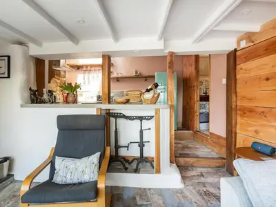a living room with a counter and a chair at Cottage Uk48457 in St Ives