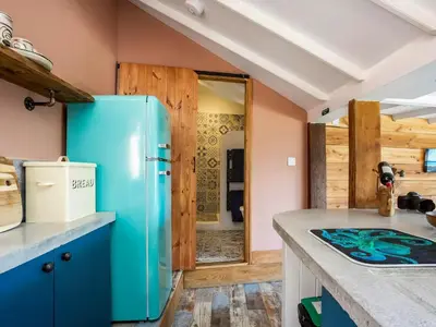 a kitchen with a blue refrigerator in a room at Cottage Uk48457 in St Ives