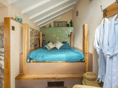 a bedroom with a bed with blue sheets at Cottage Uk48457 in St Ives