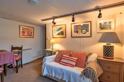 a bedroom with a bed and a table and a lamp at Finest Retreats - The Noel at Lesceave in Praa Sands
