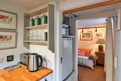 a kitchen with a refrigerator and a table with a microwave at Finest Retreats - The Noel at Lesceave in Praa Sands